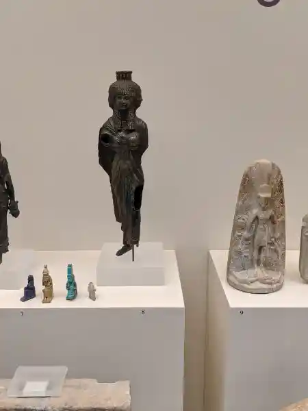 Copper alloy statuette of goddess Isis Magician wearing elaborate Egyptian headdress and robes